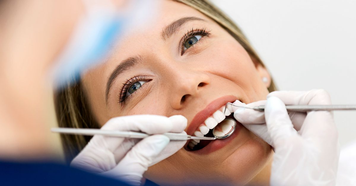 Smiling female patient receiving a dental check-up at Scotia Tower Dental clinic in downtown Vancouver, showcasing professional and gentle oral care.